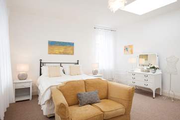 The master bedroom with seating to sit and read your morning newspaper.The super-king size bed can be converted into twin beds