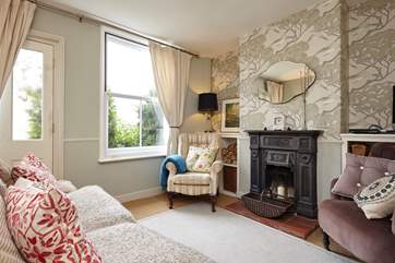 The beautifully styled sitting-room with ornamental fireplace.