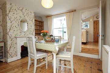 The dining-room with original wooden flooring and ornamental Victorian feature fireplace.