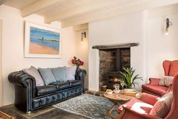 The comfy sitting-room showing some of the owner's artwork.