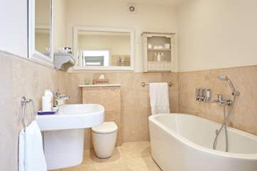 The family bathroom with free standing contemporary oval bath
