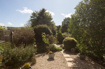 The garden has pretty planting around the gravelled areas and a patio with views down the valley.