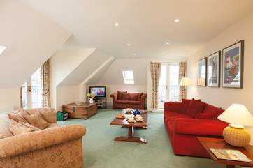 The lounge has access to the balcony that wraps around the apartment, through french doors to make the most of the sea views