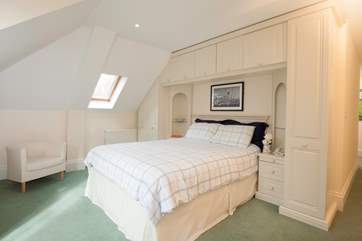 The light master bedroom has plenty of space, and also has a door out to the balcony