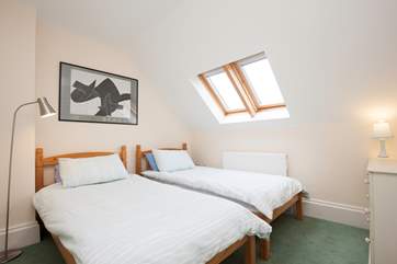The light twin bedroom is spacious and has plenty of wardrobe space
