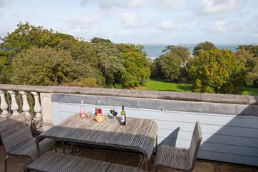 Enjoy a drink of the terrace with views through the trees to the sea
