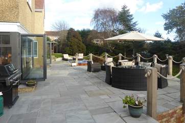 A gas barbecue allows you spend your summer days lounging on the terrace. Steep steps lead down to the enclosed lawned area.