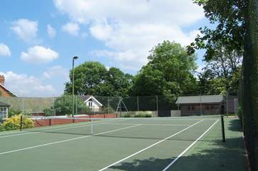 Parents can watch their children play tennis from the cottage balcony.