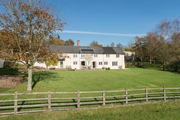 The detached barn conversion is tucked behind the main farmhouse.