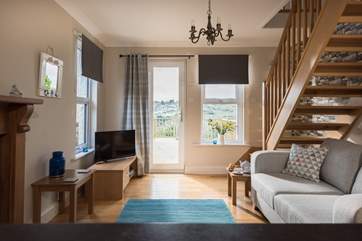 The open plan living-room has a door out to a deck with far-reaching views.
