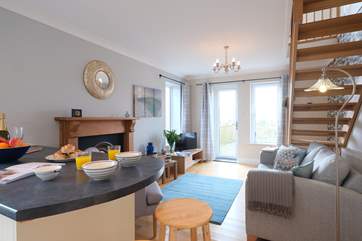 The open plan living-room has a door out to a deck with far-reaching views.