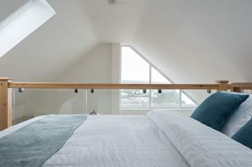 Glass balustrading allows the view to be seen from the bed.