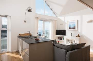 A breakfast-bar separates the kitchen and sitting areas.