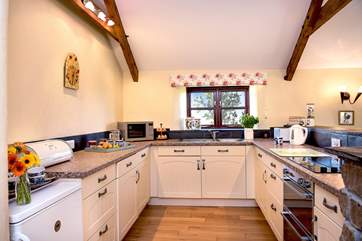 The light and airy, well-equipped kitchen.