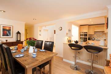 The open plan kitchen dining room with doors leading out onto the patio