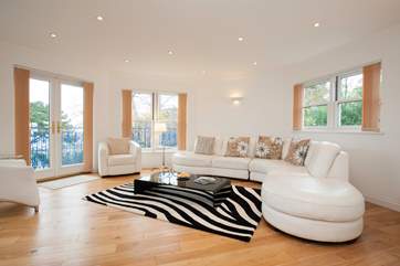The stunning top floor living-room with doors out onto the balcony and far reaching views across the Solent.