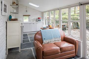 The delightful living area includes a well-equipped kitchen as well as sitting and dining areas, the perfect social space.