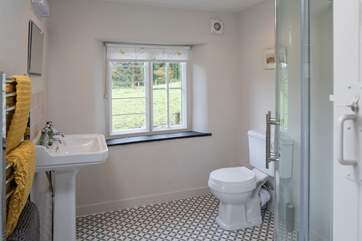 The super spacious shower-room has wonderful countryside views and the original windows - a lovely feature to add to the quirkiness of this unique retreat.