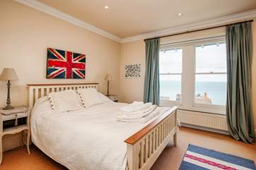 The spacious master bedroom is home to a king-size bed with sea views and and a gorgeous en suite.