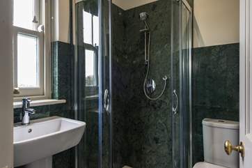 The shower cubicle in Bedroom 5 is lined with a beautiful green granite.