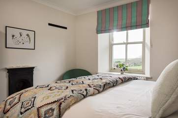 Bedroom 3 has lovely soft furnishings.