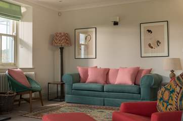Windows on three sides in the sitting-room make this a lovely, light-filled space.