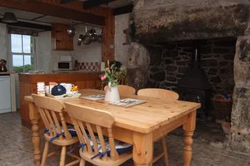 The dining-area with a huge inglenook fireplace and wood-burner.