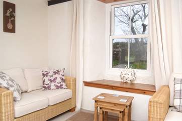 The ground floor sitting-room has views across the enclosed garden.