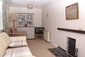 A wood-burner effect stove heats the sitting-area.
