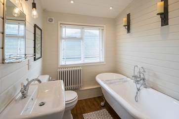 The family bathroom has a roll-top bath and hand held shower.
