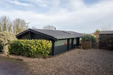 The parking area is beside the lodge, with extra space on the little lane behind.
