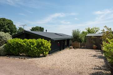 The parking area is beside the lodge, with extra space on the little lane behind.