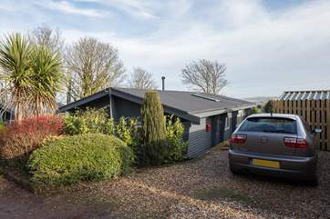 The parking area is beside the lodge, further cars can be parked on the quiet lane.