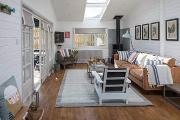 The open plan living-room with kitchen and dining areas are ideal for spending holiday time together.