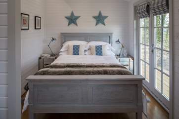 Bedroom 1 has a 5 ft bed, a door that opens onto the garden, and an en suite shower-room.