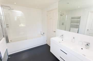 The Jack and Jill bathroom with bath, fitted shower and double sink.