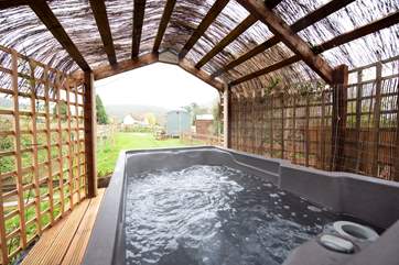 The bubbling hot tub, perfect for soaking up a starry night from - bliss!