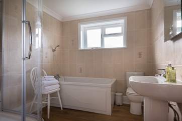 The family bathroom has both a bath and a shower cubicle.