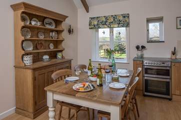 The kitchen/dining-room looks out over the garden in one direction and the courtyard in the other.