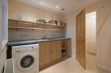 The utility-room has lots of storage space, and a cloakroom with WC and wash-basin.