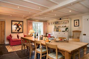 Plenty of room for everyone to gather round the kitchen the table. The French windows lead out to the garden.