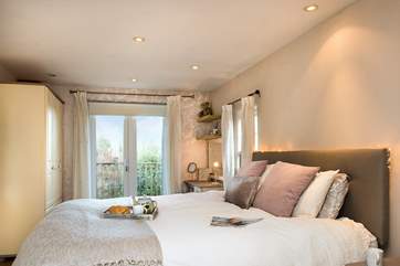 Bedroom 1 has a comfy super-king size bed and access to a balcony area.