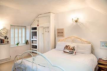 Bedroom 2 has a pretty bedstead for its king-size bed.