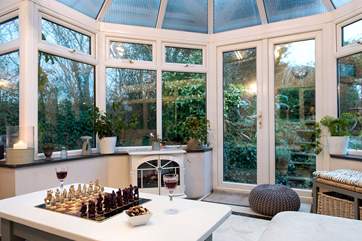 The conservatory is at the back of the cottage overlooking the garden - it has a wood-burning effect electric stove making it super cosy on chiller evenings.