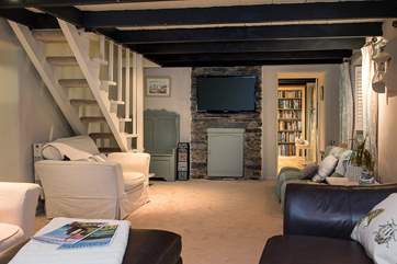 The open-tread stairs lead up from the sitting-room.