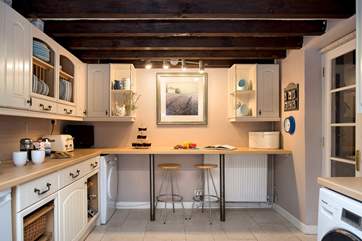 There is a breakfast-bar at one end of the kitchen.