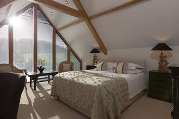 This is the master bedroom on the second floor. High ceilings and floor to ceiling windows add to the space in this gorgeous room.