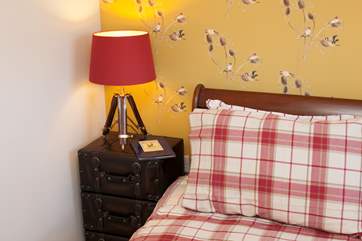 Get an early night with a good book in the inviting master bedroom.
