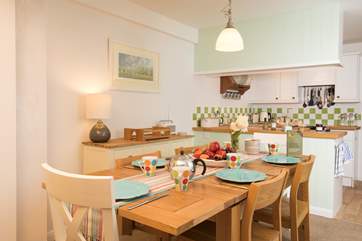 The open plan living-room with kitchen and dining area is a charming space to cook, eat and entertain in.