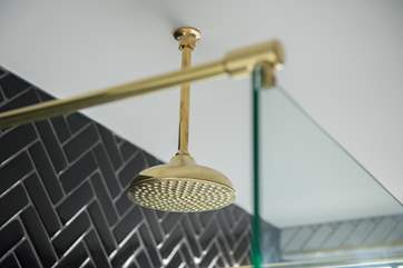 The brass shower head is a feature of the wet-room.